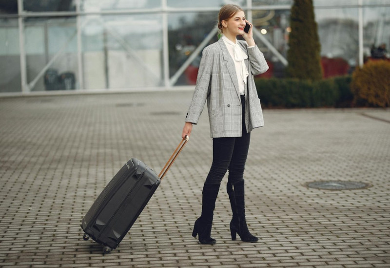 Woman wheels suitcase