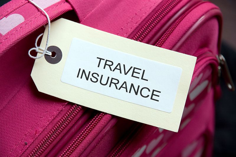 close up label on luggage that says travel insurance