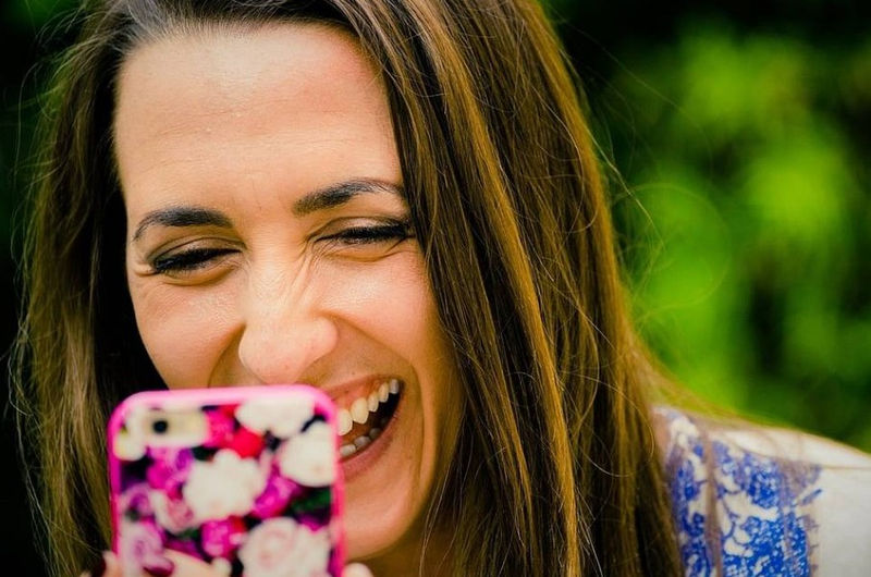 Woman laughing at phone