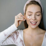 Woman Applying Skincare Products