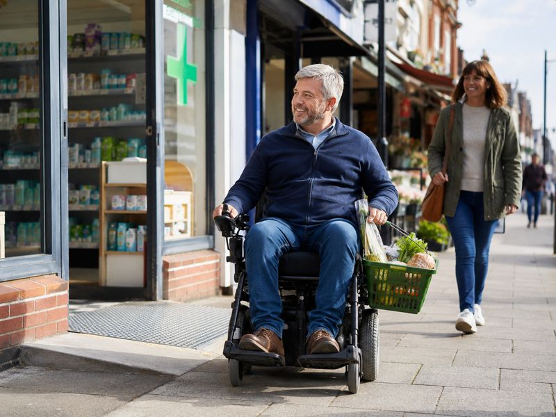 man in power chair shopping