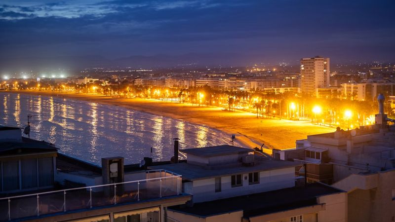 A night view of a beach and a city salou