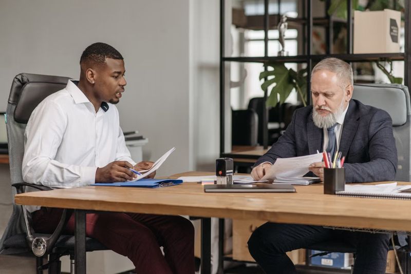 men at office table