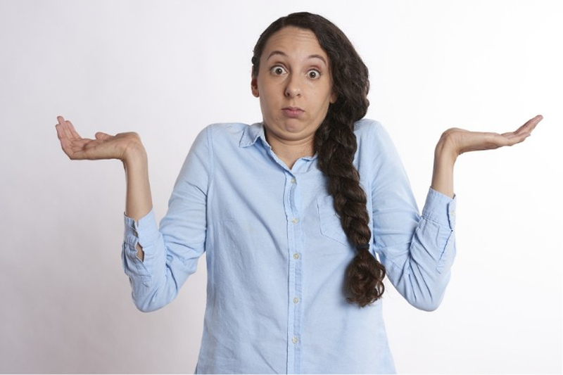 Woman Shrugging Confused
