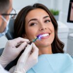 dentist using a tool on patient teeth